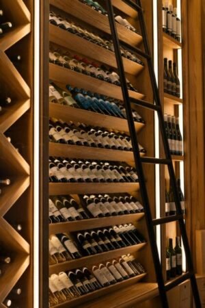 Elegant wine cellar with diverse bottles on wooden shelves in Baku.